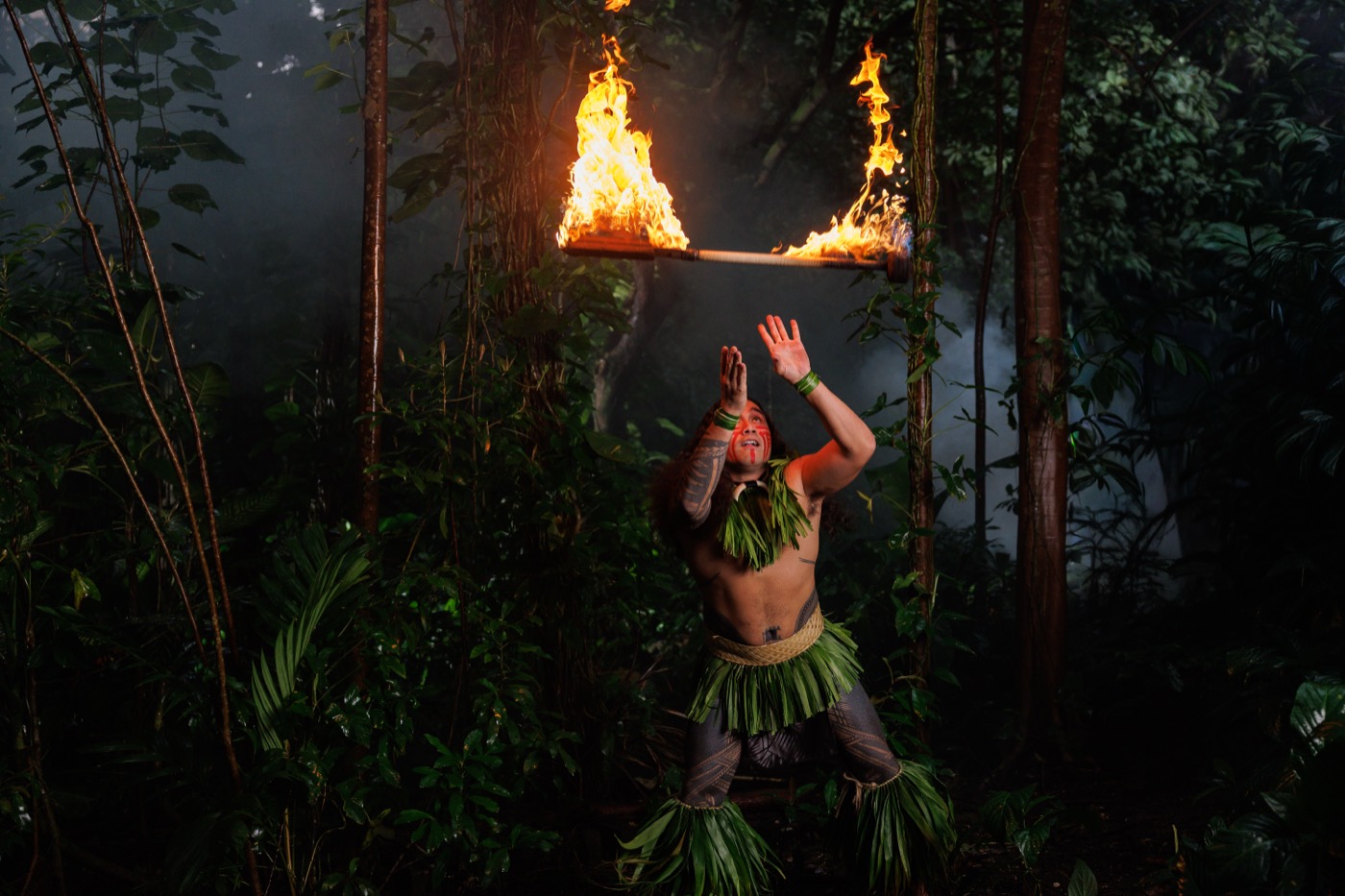 Fire knife dancer performing in the forest
